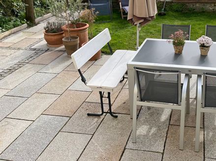 Granite_patio_slab_Girona_Antique_seating_garden_view
