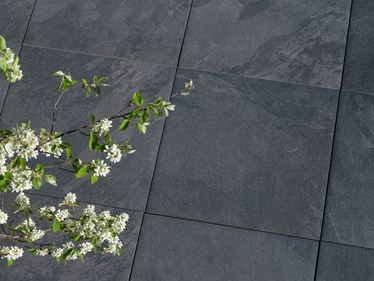 Tmavě černé břidlicové dlaždice Alpine Black s větví v popředí